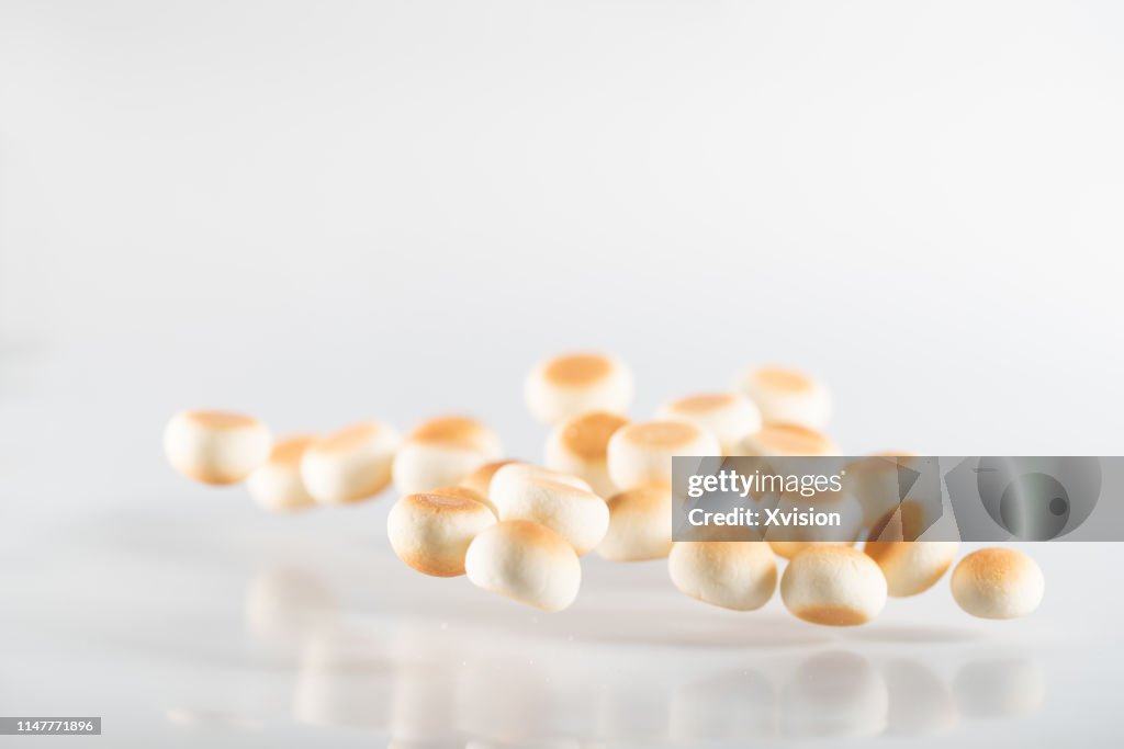 Small bread cookie jump in mid air with white background