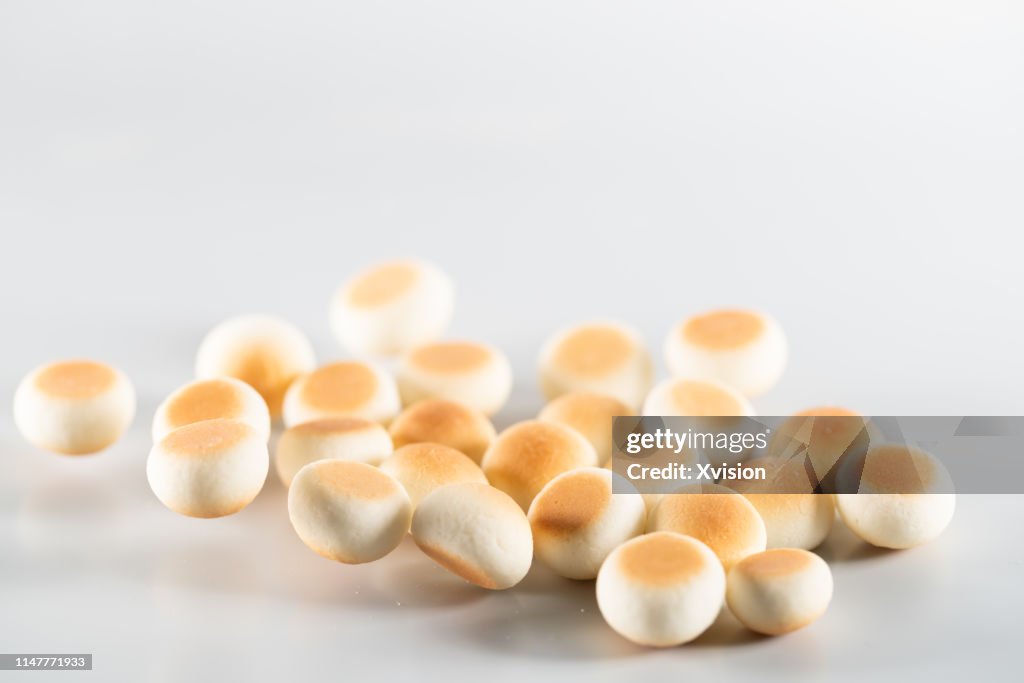 Small bread cookie jump in mid air with white background