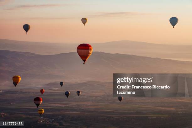 hot air balloons at sunrise in cappadocia - 気球 ストックフォトと画像