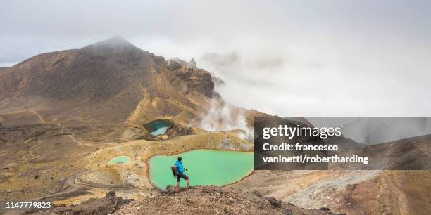 man taking photos of emerald lakes, tongariro alpine crossing, tongariro national park, unesco world heritage site, waikato region, north island, new zealand, pacific - tongariro crossing stock pictures, royalty-free photos & images