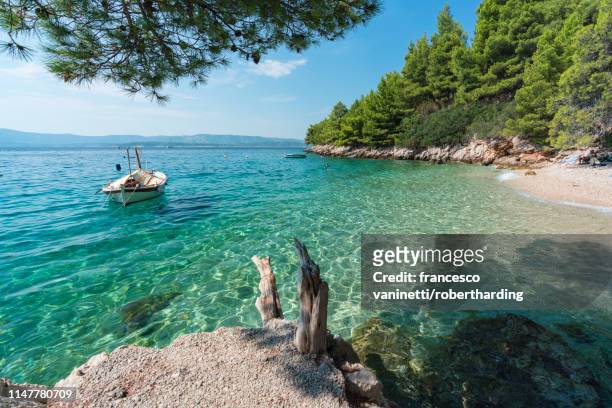 boat at dracheva beach, in summer, murvica, bol, brac island, split-dalmatia county, croatia, europe - brac island stock pictures, royalty-free photos & images
