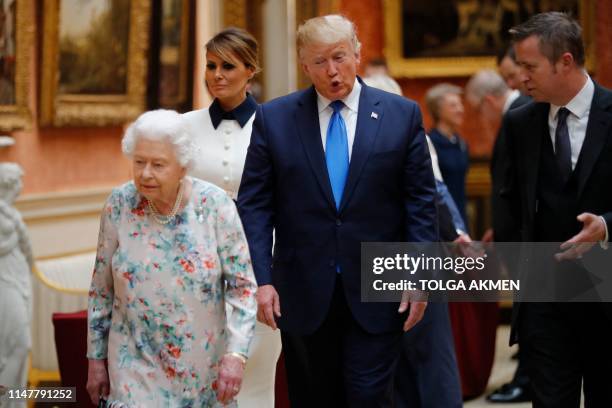 Britain's Queen Elizabeth II views a display of US items of the Royal collection with US President Donald Trump and US First Lady Melania Trump at...