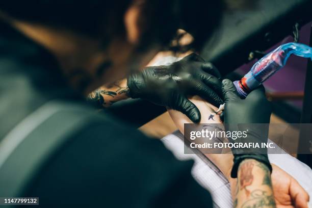 close up of tattoo during creation - tattoo needle stock pictures, royalty-free photos & images