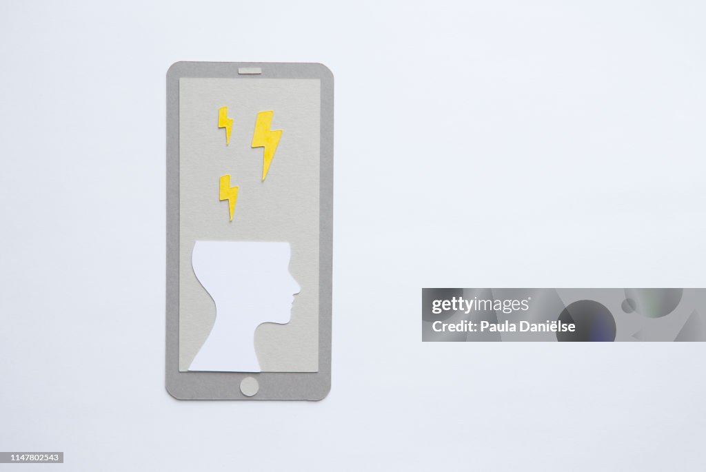 Paper mobile phone with human head and lightning