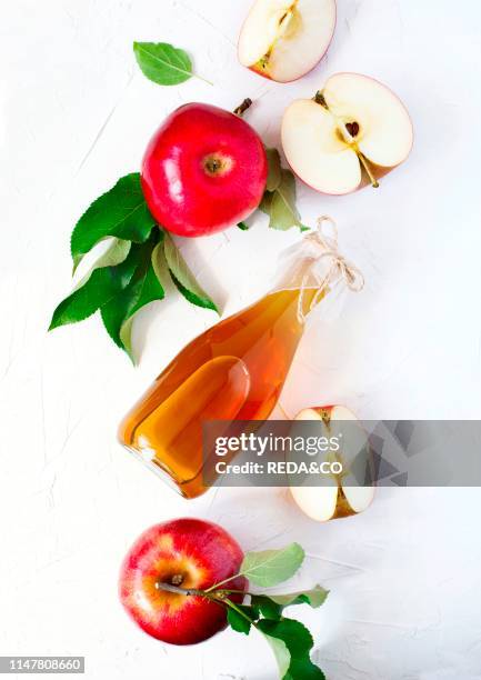 Apple cider vinegar and fresh apples, top view.