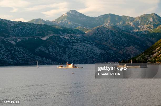 Church on the Island of Gospa od Skrpjela in the sunlight. Perast. Bay of Kotor. Montenegro. Europe.