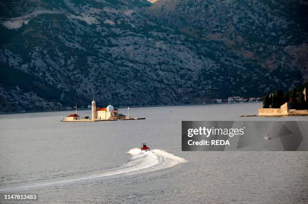 Church on the Island of Gospa od Skrpjela in the sunlight. Perast. Bay of Kotor. Montenegro. Europe.