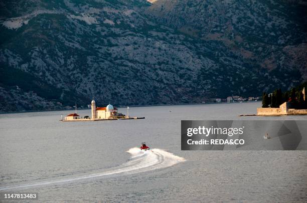 Church on the Island of Gospa od Skrpjela in the sunlight. Perast. Bay of Kotor. Montenegro. Europe.