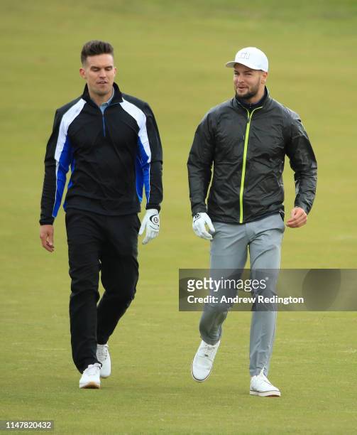 Reality TV stars Gary Beadle and Chris Hughes in action during the Pro Am prior to the start of the Betfred British Masters at Hillside Golf Club on...
