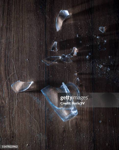 glass broken into pieces on the floor - broken glass pieces stock pictures, royalty-free photos & images