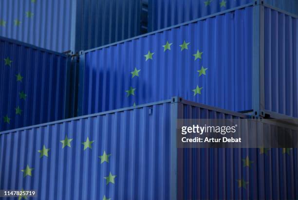 cargo containers with european union flag in the harbor. - european union symbol stock-fotos und bilder