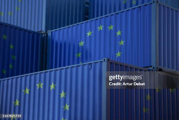 cargo containers with european union flag in the harbor. - eu trade stock pictures, royalty-free photos & images