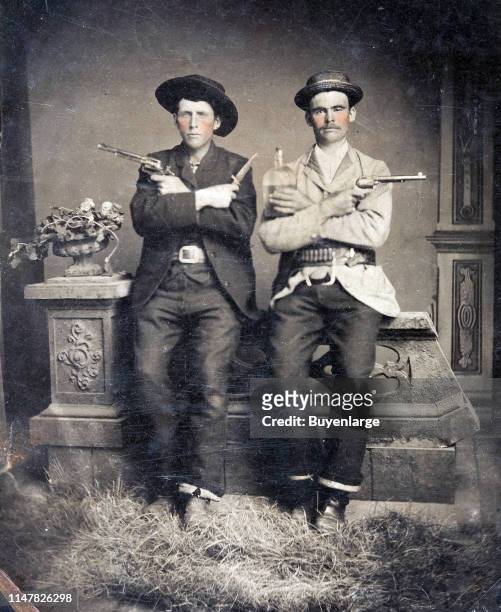 Tintype Of Two Well-Armed Western Gents, Circa 1885. Both Hold 7½' Barrel Colt Single Action Revolvers, The Figure At Left With A Bowie Knife, While...