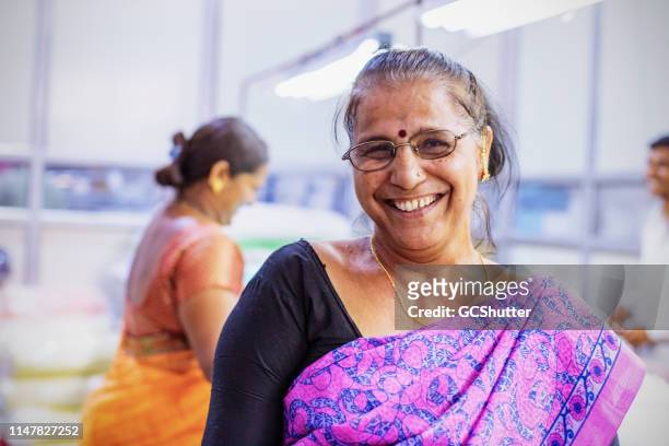 portrait of an indian female factory worker - mumbai business stock pictures, royalty-free photos & images