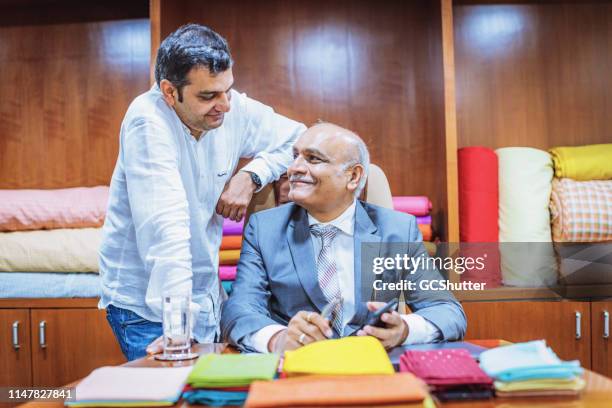 businessman with his son at their office - india office stock pictures, royalty-free photos & images