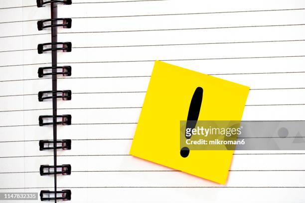 notebook with spirals and calculator and a note and exclamation mark - ausrufezeichen stock-fotos und bilder