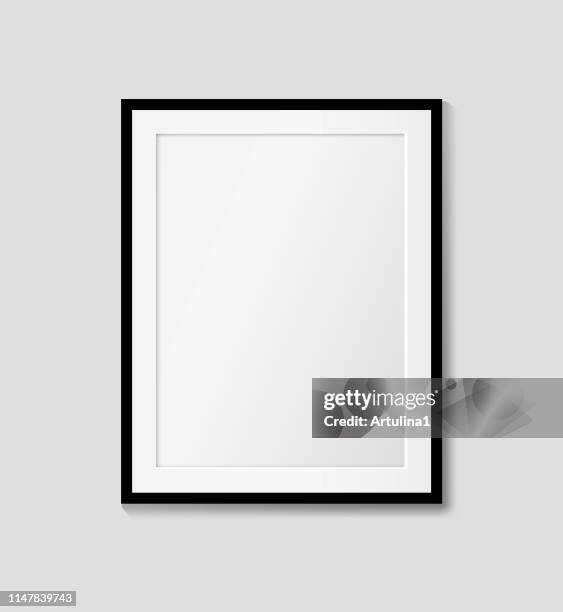 black frame with passepartout on the wall. vector picture frame mock up - modern home interior design stock illustrations