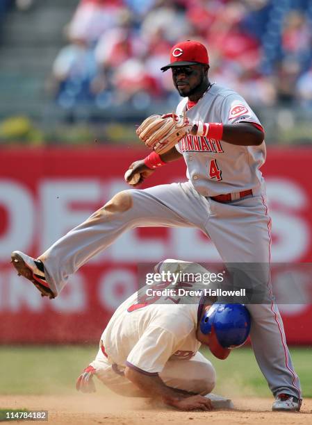 Brandon Phillips of the Cincinnati Reds steps over Raul Ibanez of the Philadelphia Phillies on an attempted double play at Citizens Bank Park on May...