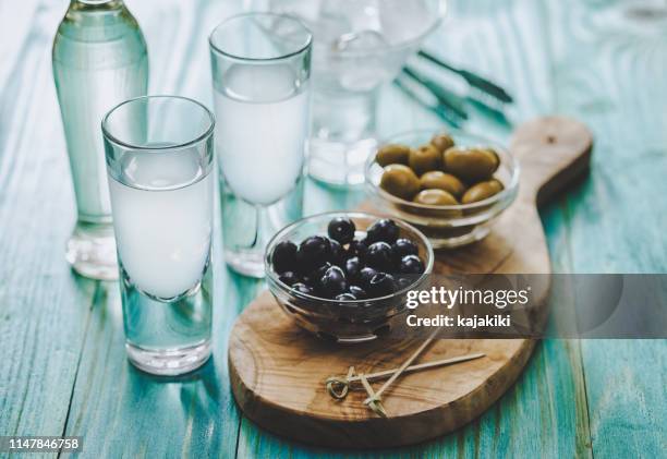 greek ouzo and olives - ouzo stock pictures, royalty-free photos & images