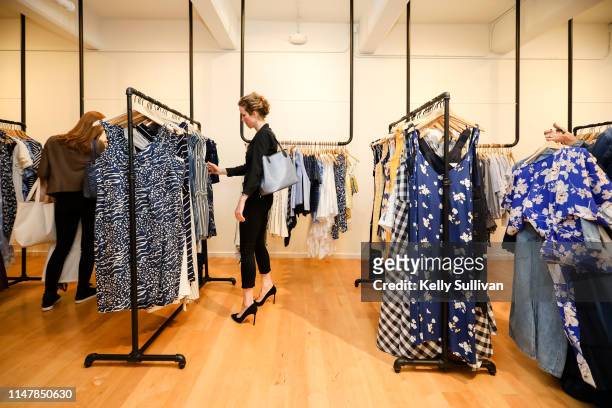Shoppers look through racks during the launch of Rent the Runway's West Coast flagship store on May 08, 2019 in San Francisco, California.