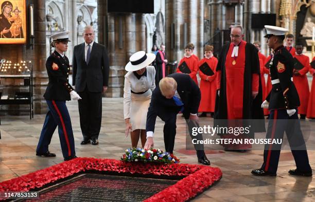 President Donald Trump and US First Lady Melania Trump, watched by Britain's Prince Andrew, Duke of York, and the Dean of Westminster, John Hall as...