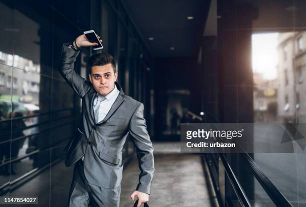 disappointed businessman throwing phone - rich fury stock pictures, royalty-free photos & images