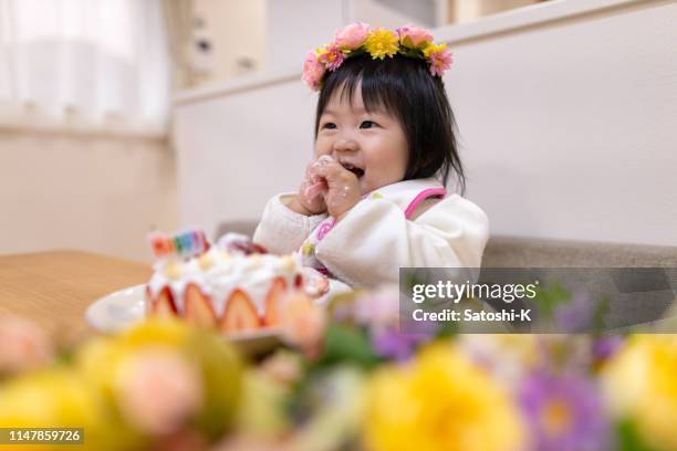 baby girl smashing cake for her first birthday - demolished cake stock pictures, royalty-free photos & images