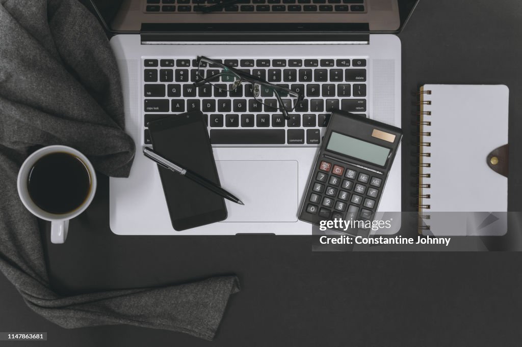 Laptop and Office Supply Items on Work Desk
