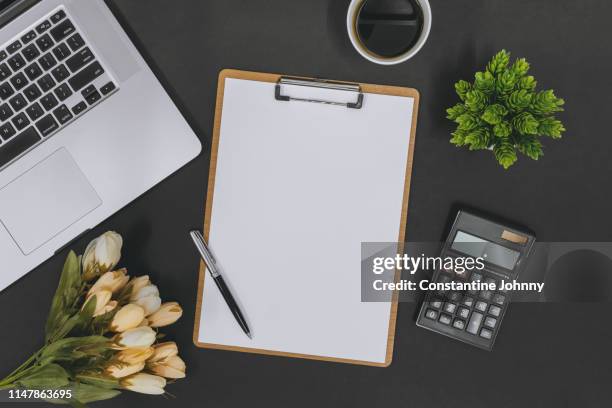 paper on clipboard and laptop on work desk - calculator top view stock pictures, royalty-free photos & images