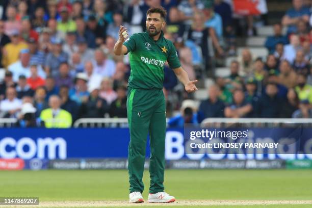 Pakistan's Mohammad Amir reacts after been penalised for bowling a wide delivery during the 2019 Cricket World Cup group stage match between England...