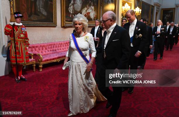 Britain's Camilla, Duchess of Cornwall walks with US Ambassador to the UK Woody Johnson , Britain's Prime Minister Theresa May , Britain's Catherine,...