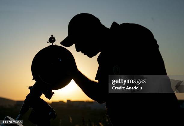 Group of Tunisian observer using binoculars and telescope gather for observing the new crescent moon which marks the end of the Muslim fasting month...