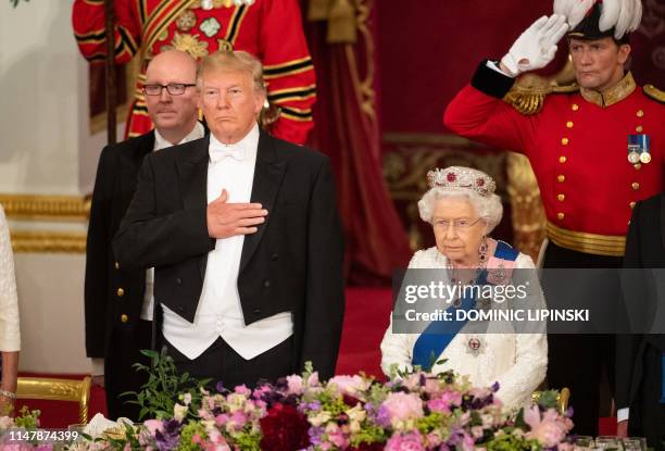 Britain's Queen Elizabeth II hosts US President Donald Trump and the US First Lady for a State Banquet in the ballroom at Buckingham Palace in...