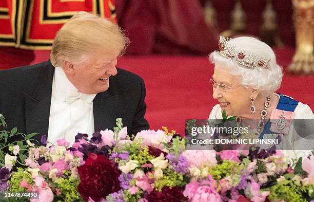Britain's Queen Elizabeth II laughs with US President Donald Trump during a State Banquet in the ballroom at Buckingham Palace in central London on...