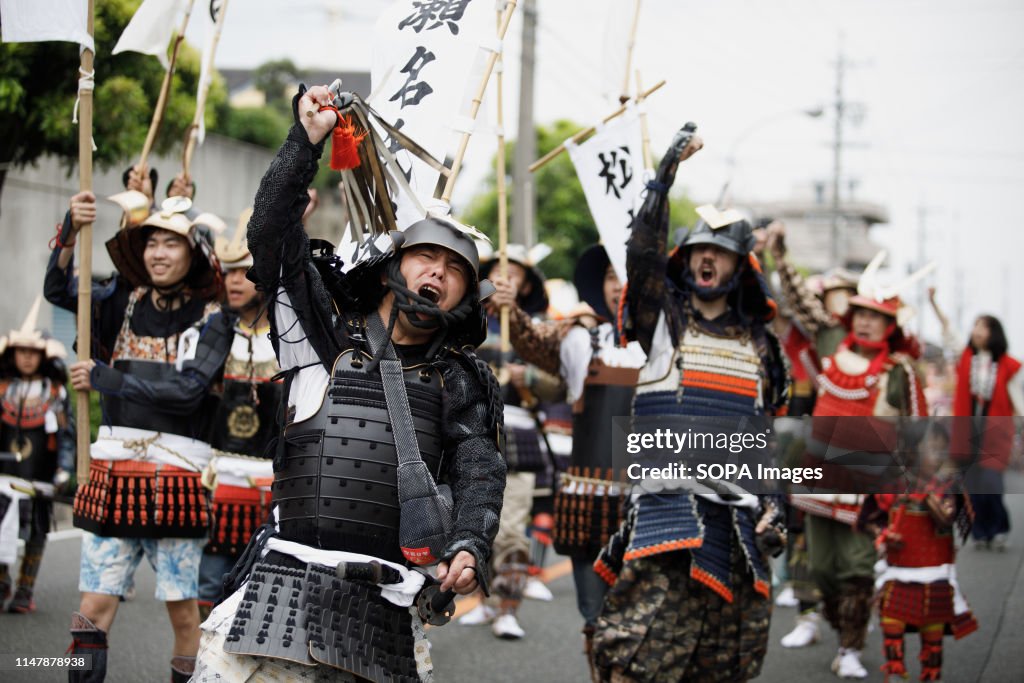 Men dressed in samurai warrior armour chants slogans during...