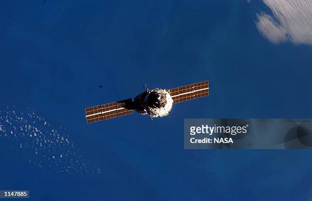 The mated Russian-built Zarya and U.S.-built Unity modules are backdropped against the blackness of space over Earth's horizon shortly after leaving...