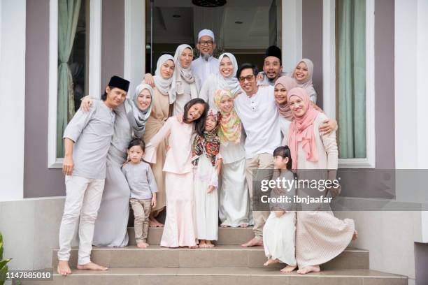 family standing in front of house - family photo shoot stock pictures, royalty-free photos & images