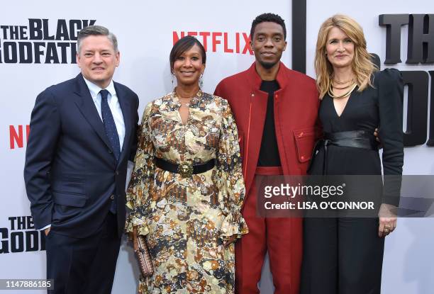 Netflix's CEO Ted Sarandos, wife Nicole Avant, US actors Chadwick Boseman and Laura Dern attends Netflix's "The Black Godfather" premiere at...