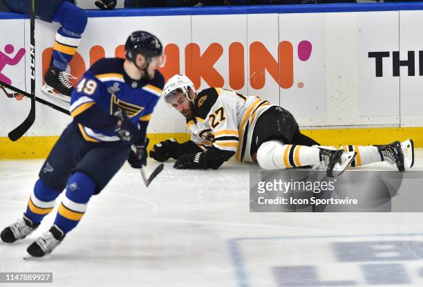 Boston Bruins defenseman John Moore falls to the ice during Game 4 of the Stanley Cup Final between the Boston Bruins and the St. Louis Blues, on...