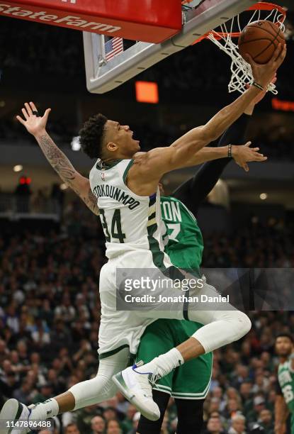 Giannis Antetokounmpo of the Milwaukee Bucks goes up against Daniel Theis of the Boston Celtics at Fiserv Forum on May 08, 2019 in Milwaukee,...