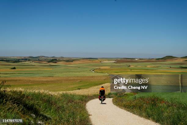 pilgrim cycling in the camino de santiago. - camino de santiago stock pictures, royalty-free photos & images