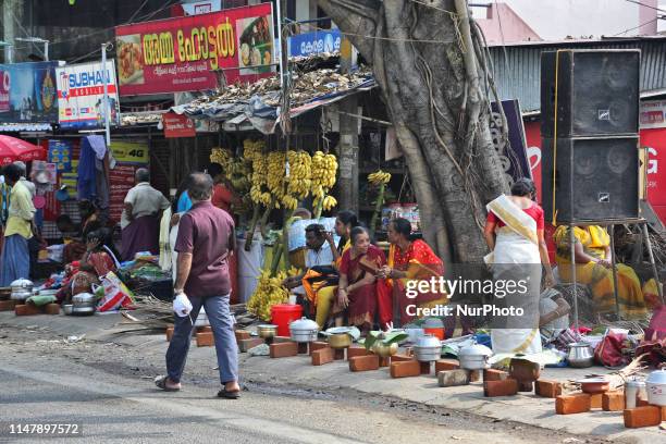 Hindu women finish final preparations and wait for the signal to begin cooking pongala along the roadside on the morning of the final day of the 10...