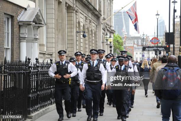 Police officers take security measures during a protest against U.S President Donald Trump at Trafalgar Square in London, United Kingdom on June 4,...