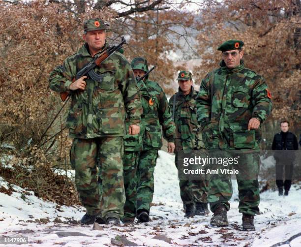 Commander of the Obrinje region of the Kosovo Liberation Army Gani Koci, right, trains with his troops Monday, December 14, 1998. Monday night over...