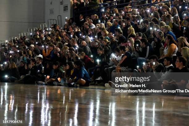 Students and parents hold up phone lights during a vigil for Kendrick Castillo in the gymnasium at Highlands Ranch High School on May 8, 2019 in...
