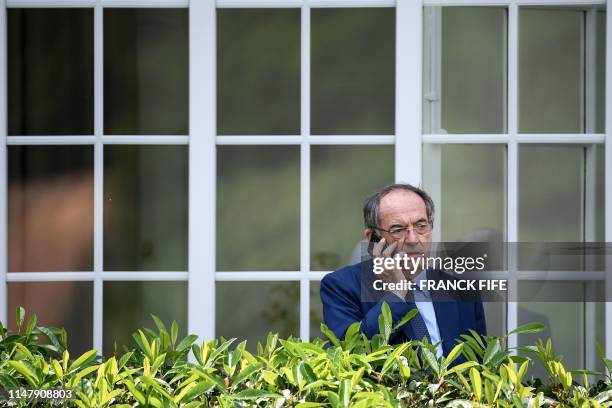 French Football Federation president Noel le Graet speaks on the phone prior to the arrival of French President in Clairefontaine-en-Yvelines,...