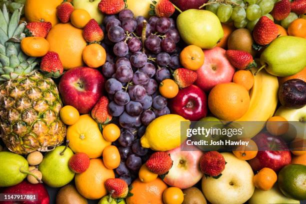 colorful fruit background - beerenfrüchte stock-fotos und bilder