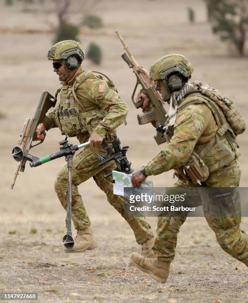 An Australian Army soldier runs with a EF88 Austyer rifle during Exercise Chong Ju at the Puckapunyal Military Area on May 09, 2019 in Seymour,...