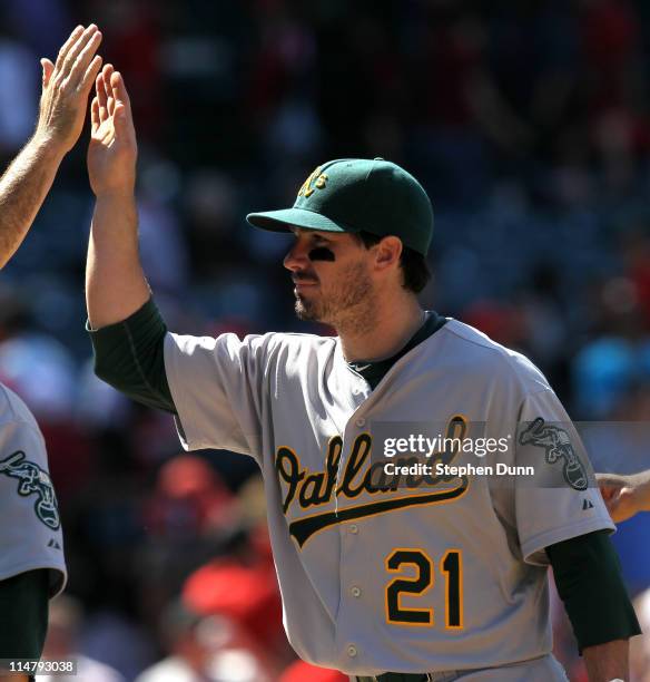 Andy LaRoche of the Oakland Athletics celebrates with teammates after the game with the Los Angeles Angels of Anaheim on May 26, 2011 at Angel...