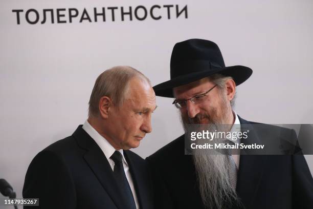 Russian President Vladimir Putin listens to Main Rabbi of Russia Berl Lazar during the unveiling ceremony of the Monument to the Heroes of Resistance...